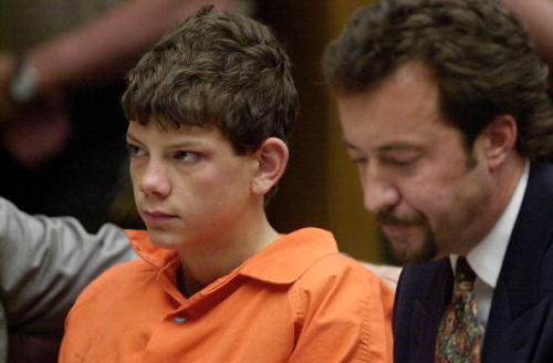 Charles ‘Andy’ Williams, a 15-year old student from Santana High School sits with his attorney Randy Mize during his arraignment for murder in the death of two fellow students at the California Superior Court in El Cajon, California 07 March, 2001. Two students were killed and 13 wounded when he opened fire in a boys bathroom in the school March 5, 2001.
